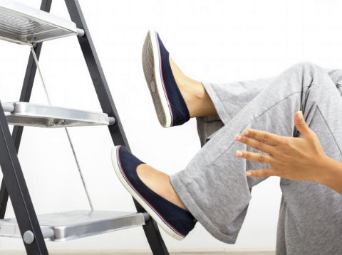 Woman falling from a step ladder